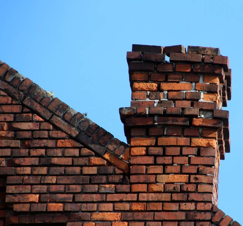 Damaged chimney on an Woodstock home showing cracks and missing mortar